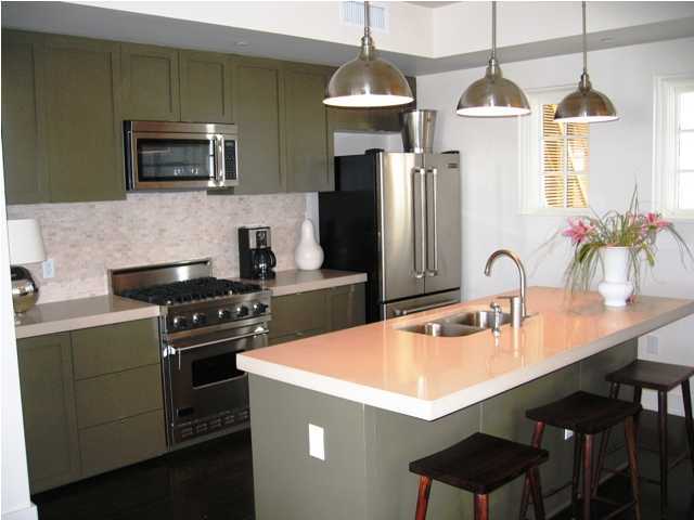 136 Unit Ave Inlet Beach, Unit 3B 1 Inlet Beach, FL 32461 - Photo 5 of 8 a kitchen with stainless steel appliances a sink a stove a refrigerator cabinets and a counter top space