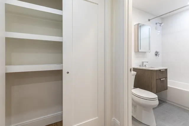 a bathroom with a toilet a sink and shower