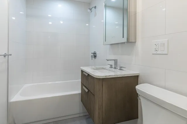 a bathroom with a sink a toilet and bathtub