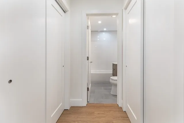 a bathroom with a toilet and a glass door