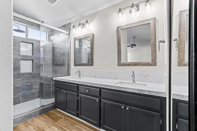 a bathroom with a double vanity sink mirror and