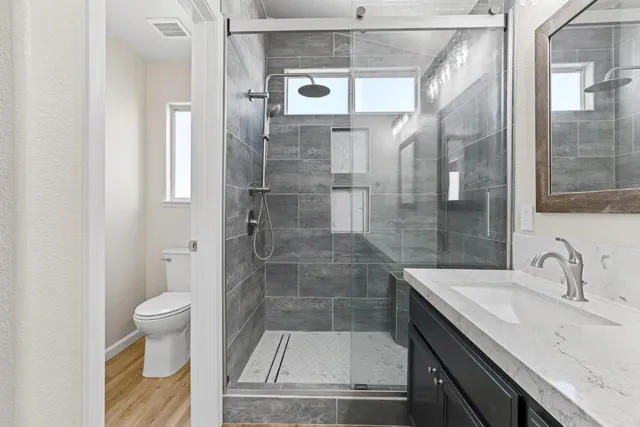 a bathroom with a sink toilet and shower