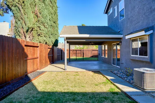 a view of an house with backyard and sitting area