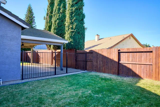 a view of backyard with a garden and deck