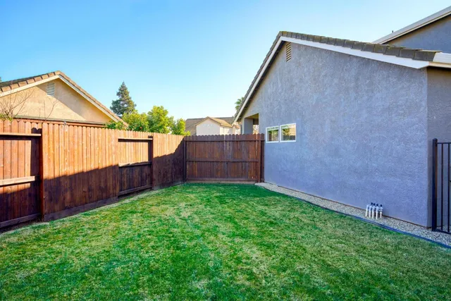 an aerial view of residential houses with outdoor space and parking