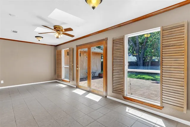 a view of a livingroom with a ceiling fan and window