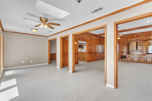a view of a livingroom with a hall and kitchen view