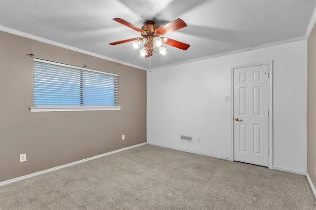 an empty room with closet and fan
