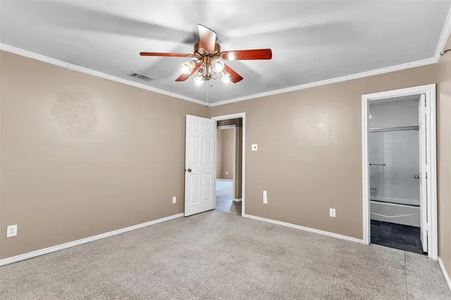 a view of an empty room with a ceiling fan