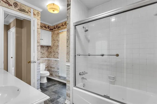 a bathroom with a shower and a toilet