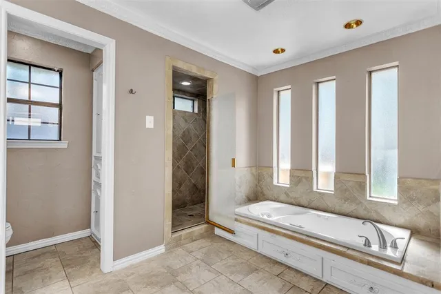 a spacious bathroom with a granite countertop tub and a sink