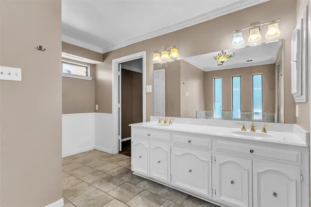 a spacious bathroom with a double vanity sink and a mirror