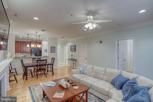 a living room with furniture a dining table and a rug