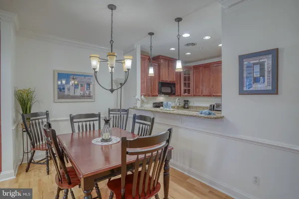 a view of a dining room with furniture wooden floor and a chandelier