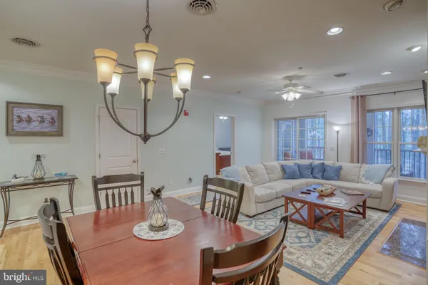 a living room with furniture a fireplace and a chandelier