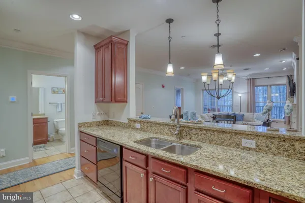 a view of a kitchen with a sink and chandelier