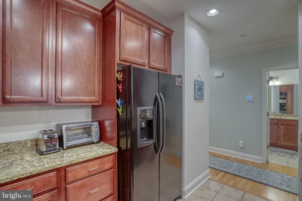 a kitchen with stainless steel appliances granite countertop a refrigerator and a sink