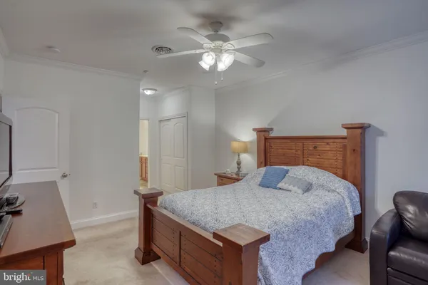 a bedroom with a large bed and a chandelier