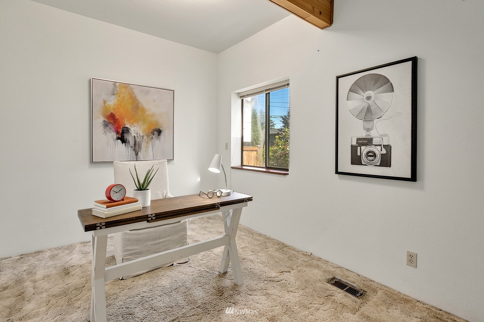 738 North 87th Street Seattle, WA 98103 - Photo 12 of 16 a room with a wall paintings on the wall and a window