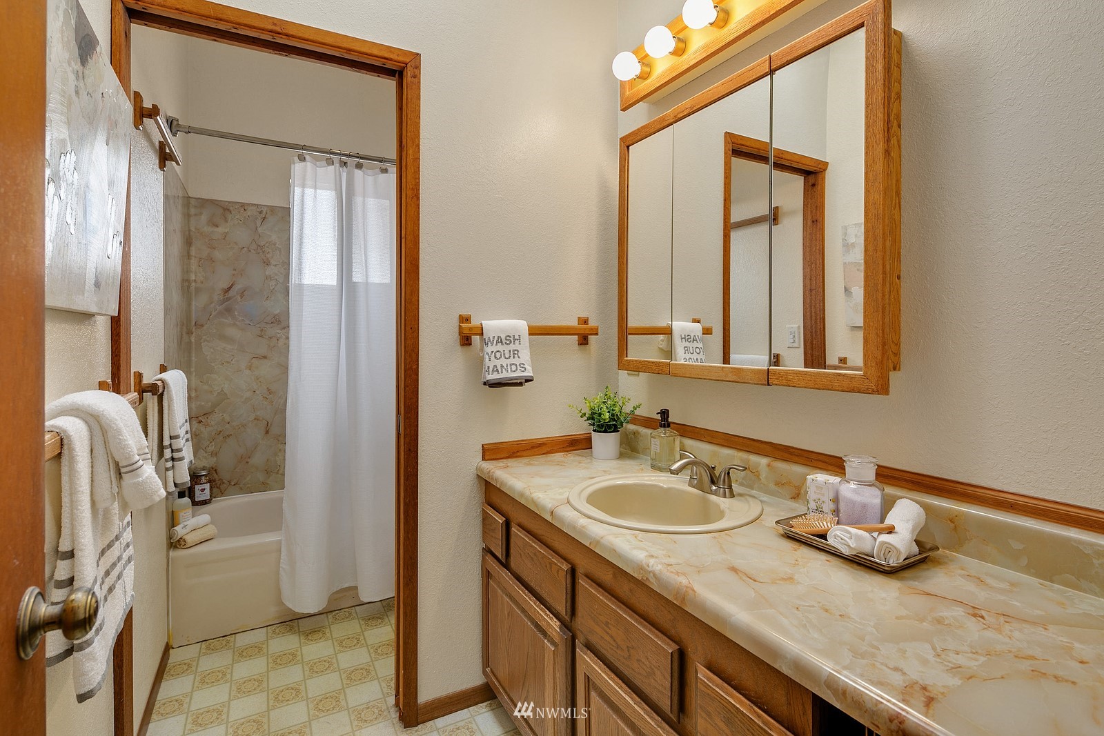 738 North 87th Street Seattle, WA 98103 - Photo 14 of 16 a bathroom with a granite countertop sink and a mirror