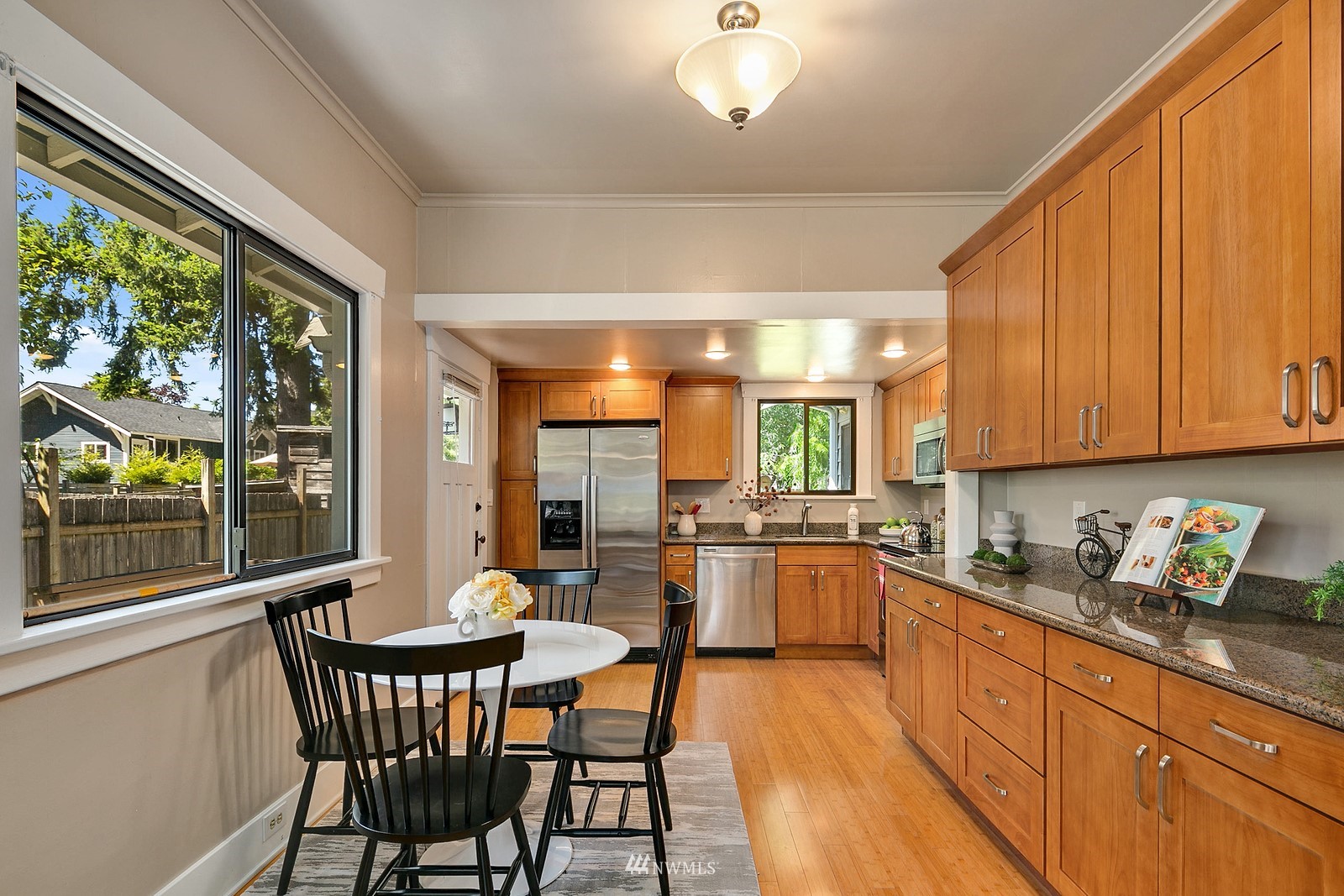 738 North 87th Street Seattle, WA 98103 - Photo 8 of 16 a kitchen with a table chairs stove and cabinets