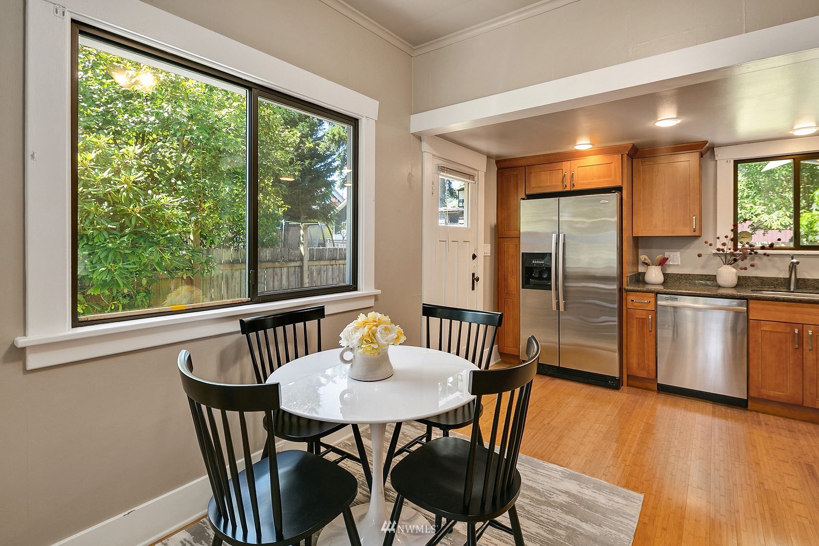 738 North 87th Street Seattle, WA 98103 - Photo 9 of 16 a kitchen with stainless steel appliances granite countertop a dining table and chairs