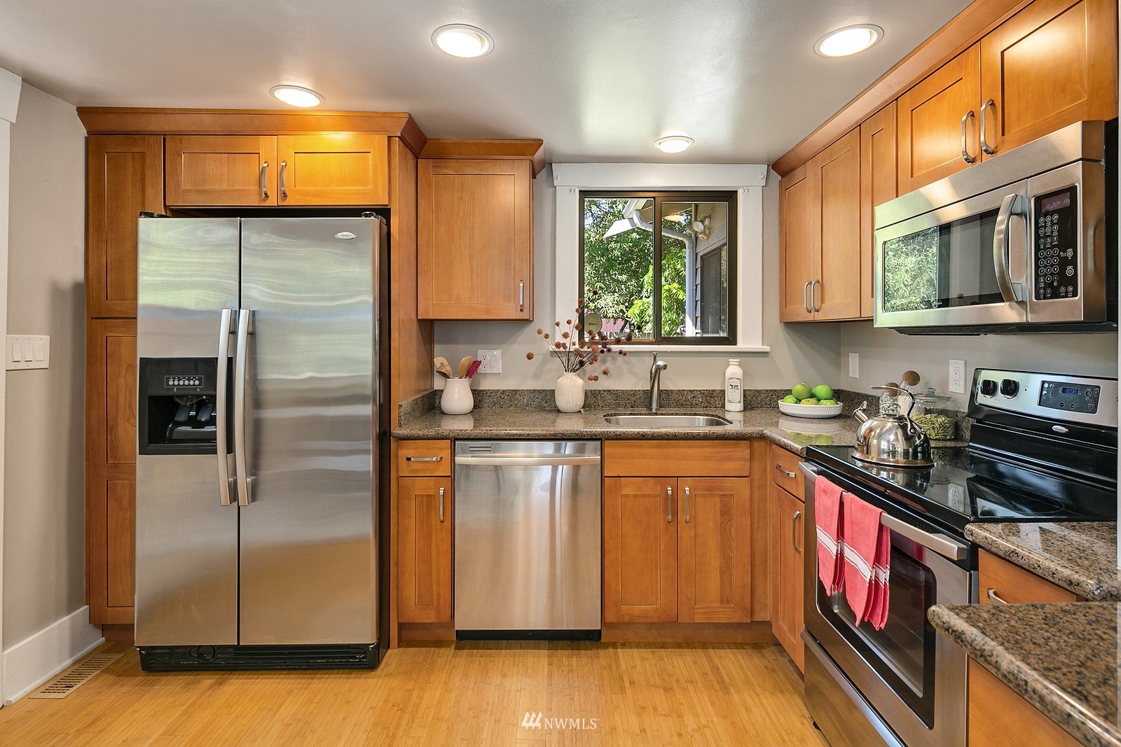 738 North 87th Street Seattle, WA 98103 - Photo 10 of 16 a kitchen with stainless steel appliances granite countertop a refrigerator a sink and a stove