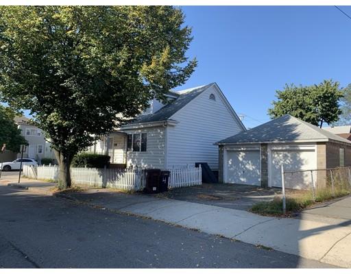 4 Baker Road Everett, MA 02149 - Photo 2 of 11 a front view of a house with a yard and garage