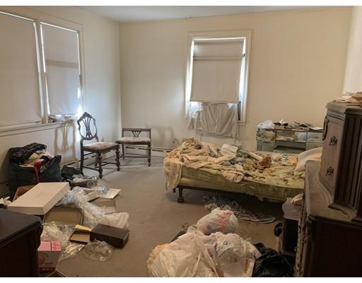 4 Baker Road Everett, MA 02149 - Photo 3 of 11 a bedroom with furniture and a bed