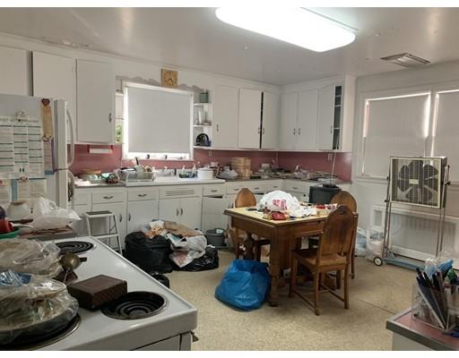 4 Baker Road Everett, MA 02149 - Photo 5 of 11 a kitchen with a table and chairs in it