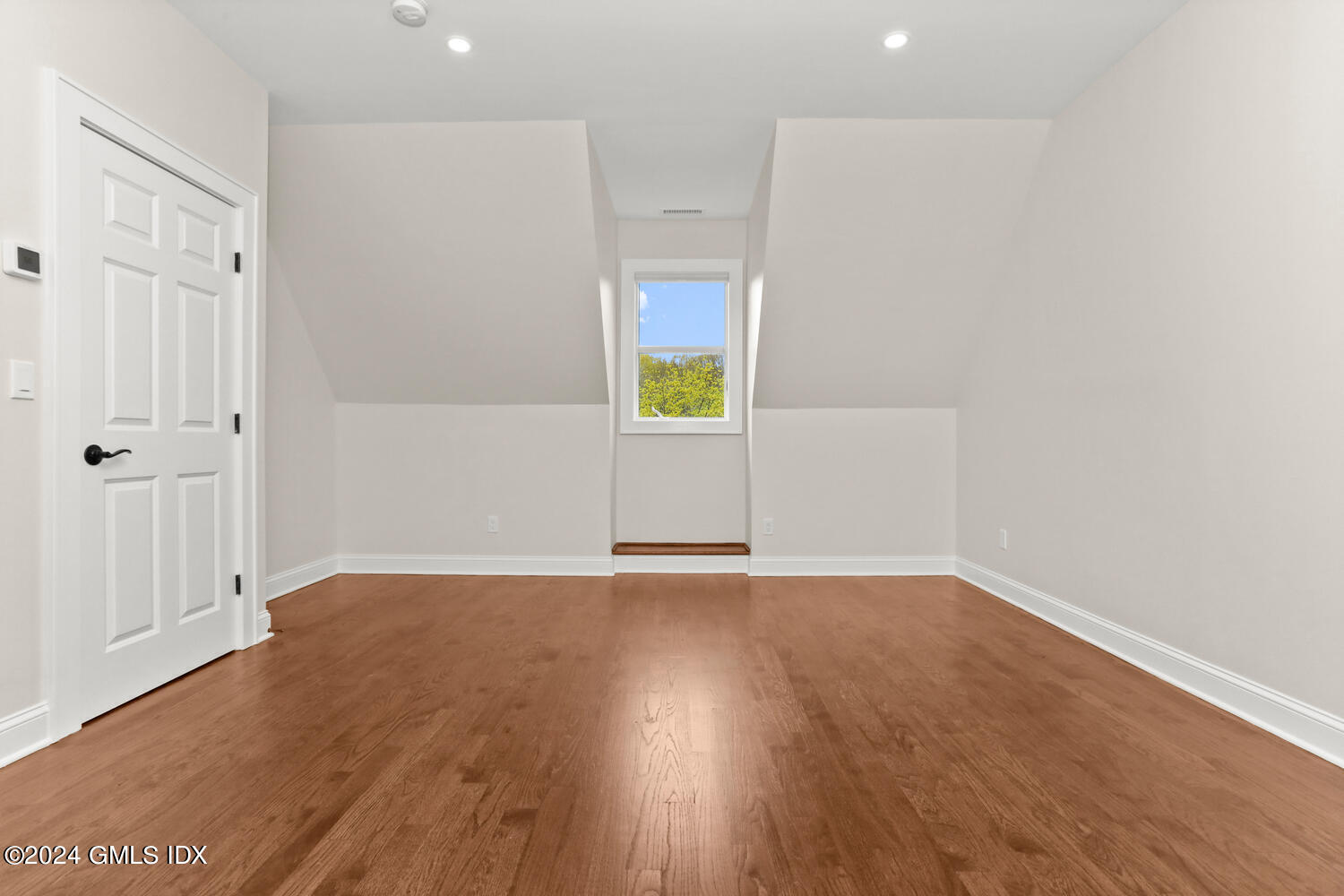 44 Riversville Road, Unit UPSTAIRS Greenwich, CT 06831 - Photo 17 of 24 an empty room with wooden floor and windows