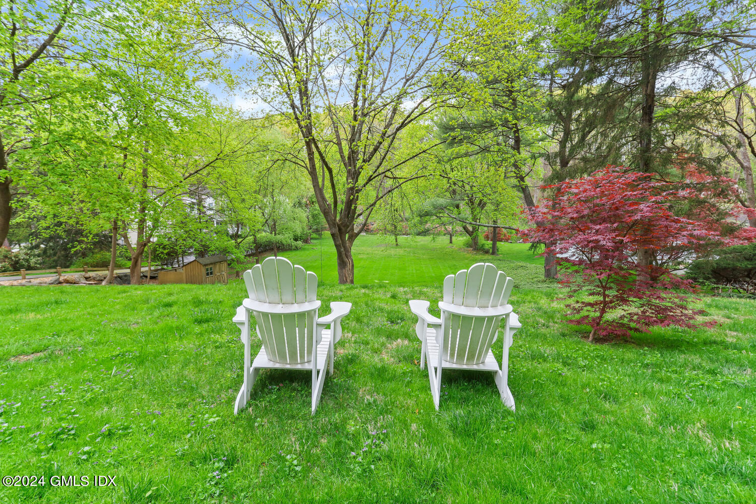 44 Riversville Road, Unit UPSTAIRS Greenwich, CT 06831 - Photo 21 of 24 a view of a table and chair in the garden