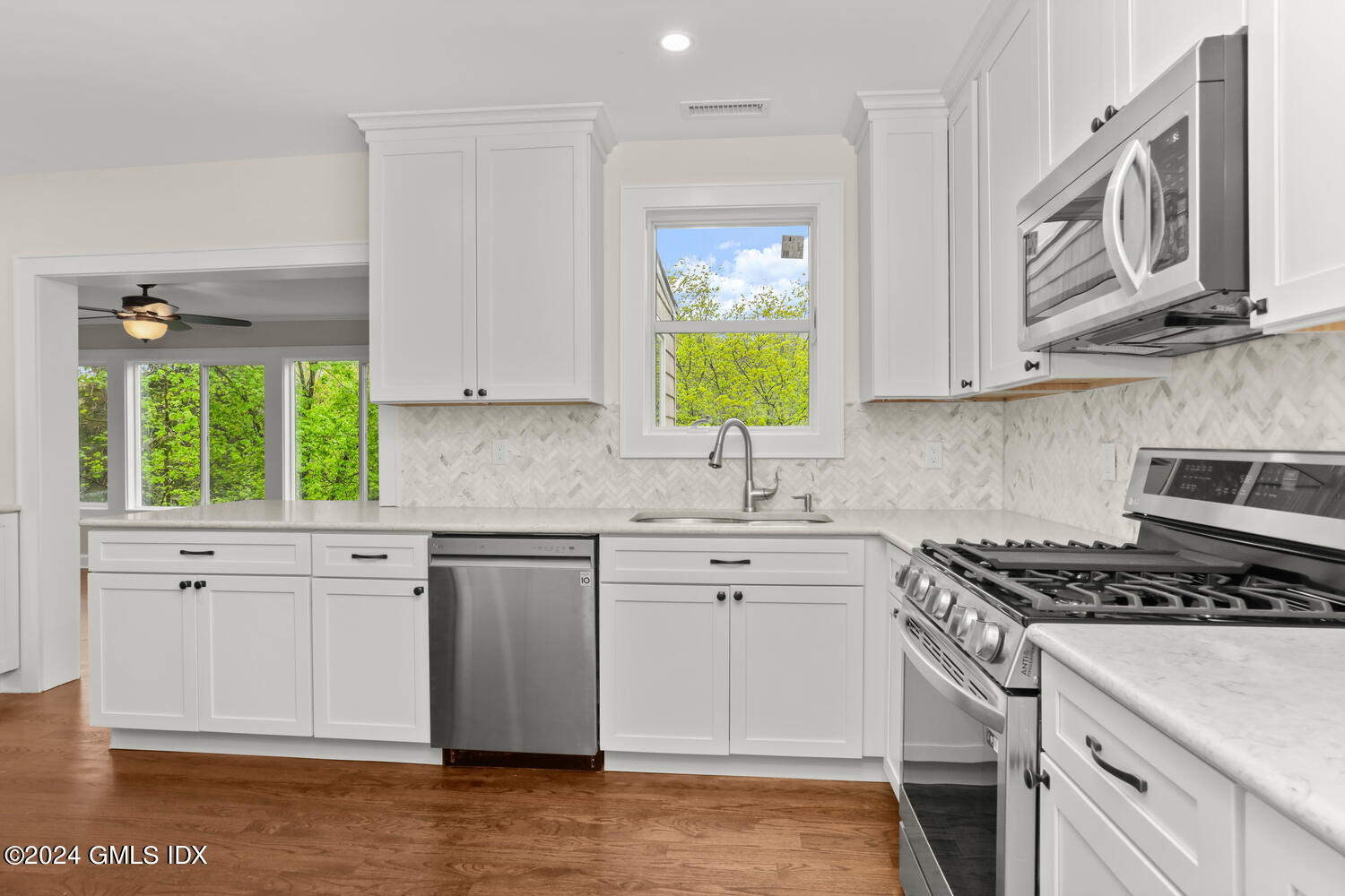 44 Riversville Road, Unit UPSTAIRS Greenwich, CT 06831 - Photo 4 of 24 a kitchen with stainless steel appliances granite countertop a sink stove and cabinets