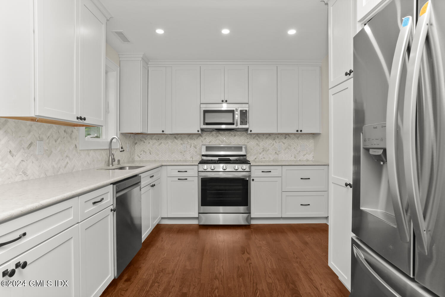 44 Riversville Road, Unit UPSTAIRS Greenwich, CT 06831 - Photo 5 of 24 a kitchen with granite countertop white cabinets and stainless steel appliances