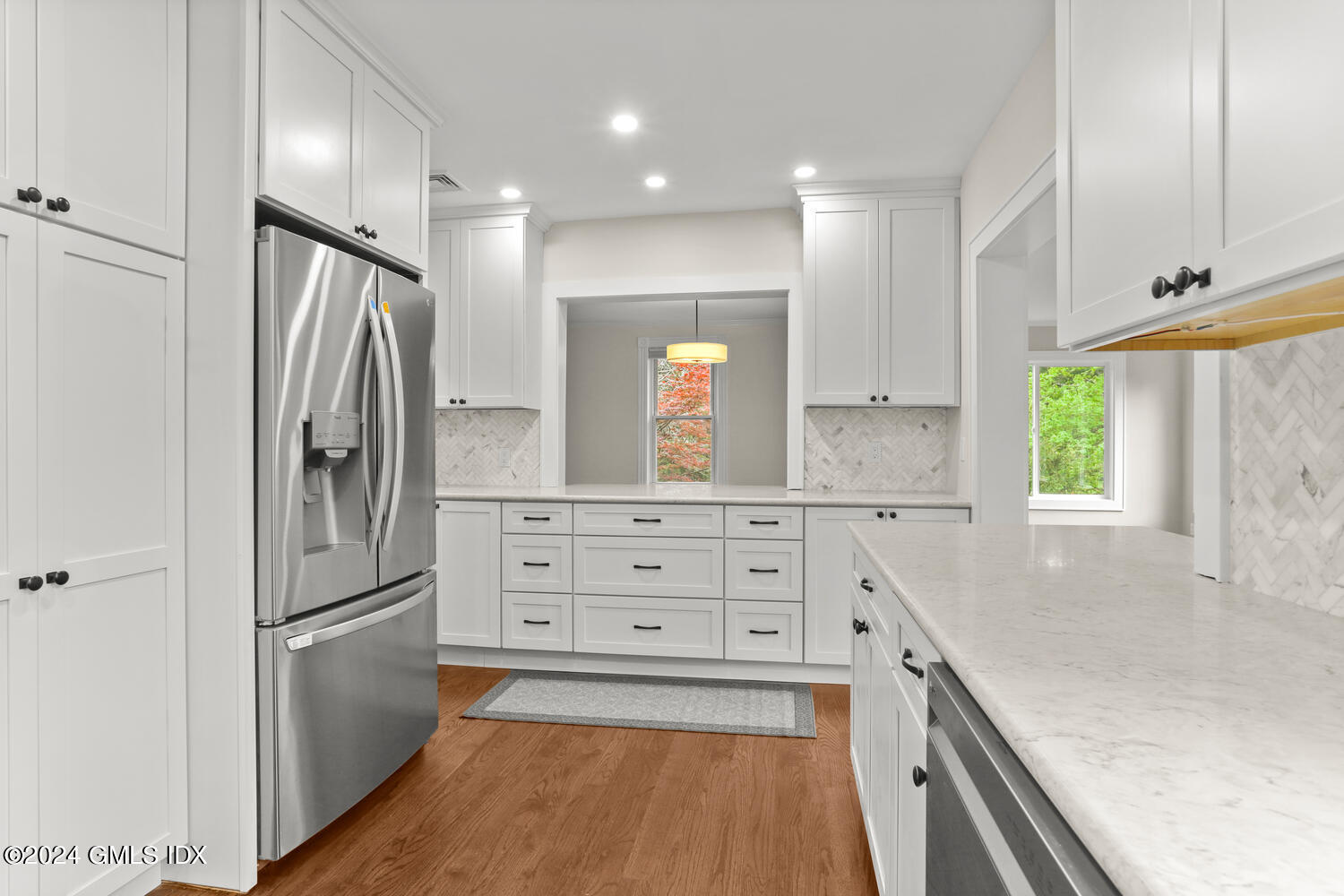 44 Riversville Road, Unit UPSTAIRS Greenwich, CT 06831 - Photo 6 of 24 a kitchen with white cabinets and stainless steel appliances