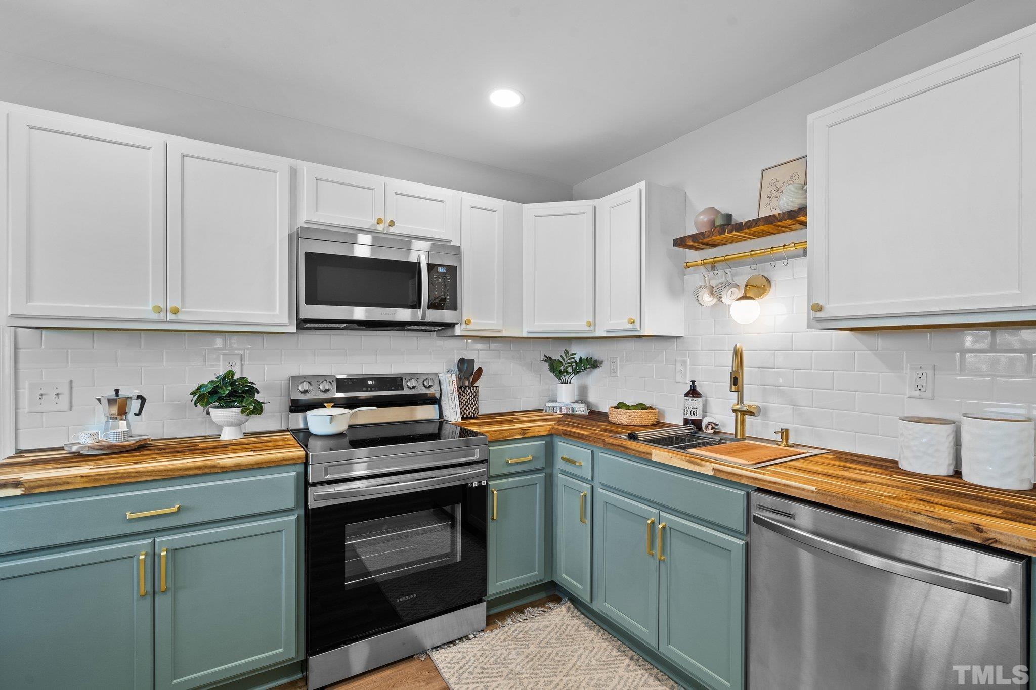 1013 Mockingbird Drive Raleigh, NC 27615 - Photo 13 of 41 a kitchen with stainless steel appliances granite countertop a sink and a stove