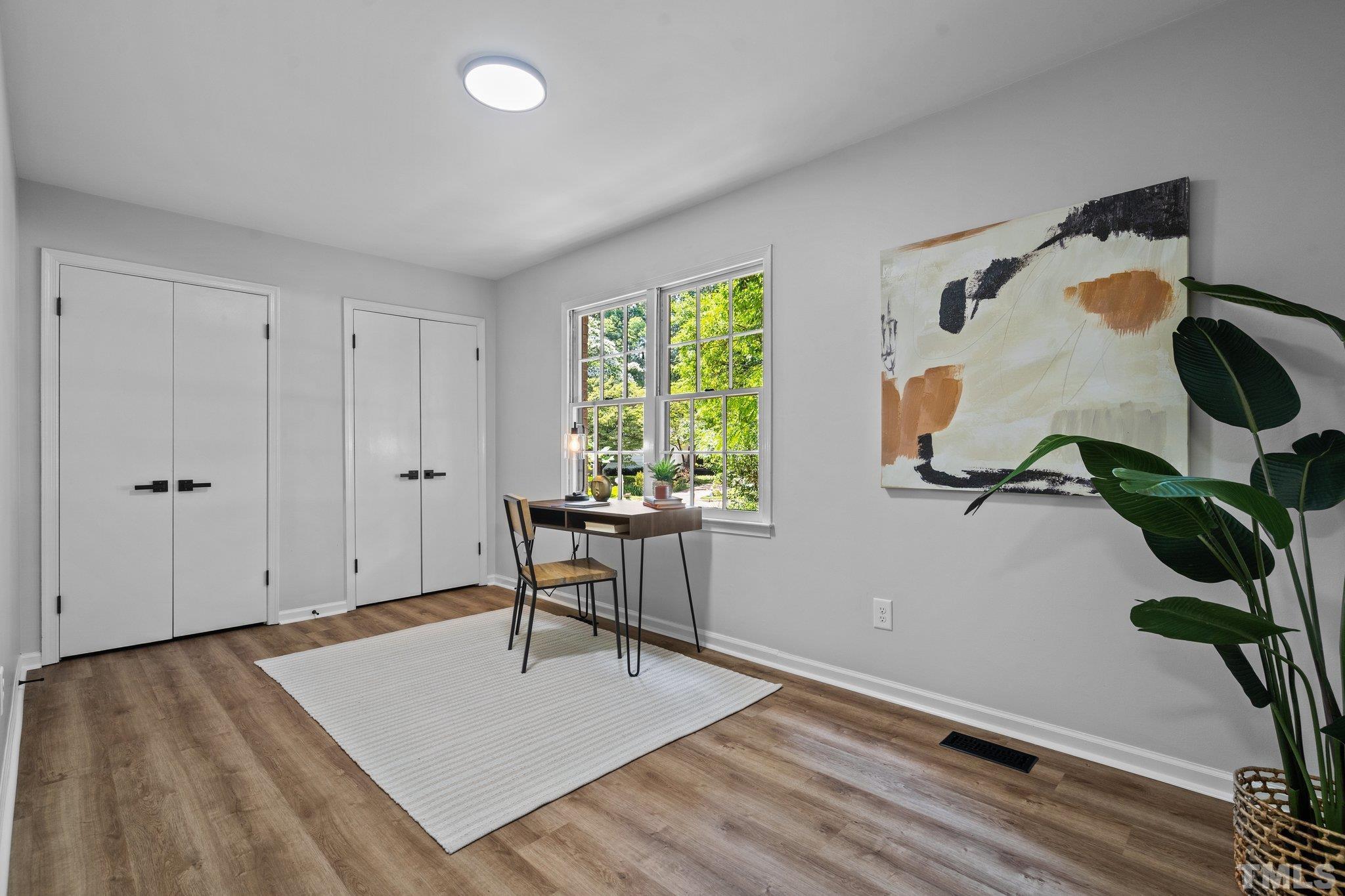 1013 Mockingbird Drive Raleigh, NC 27615 - Photo 18 of 41 a view of workspace with wooden floor and windows