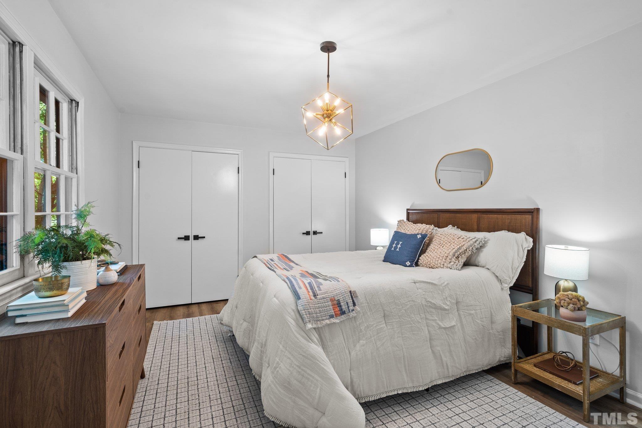 1013 Mockingbird Drive Raleigh, NC 27615 - Photo 25 of 41 a bedroom with a bed and wooden floor