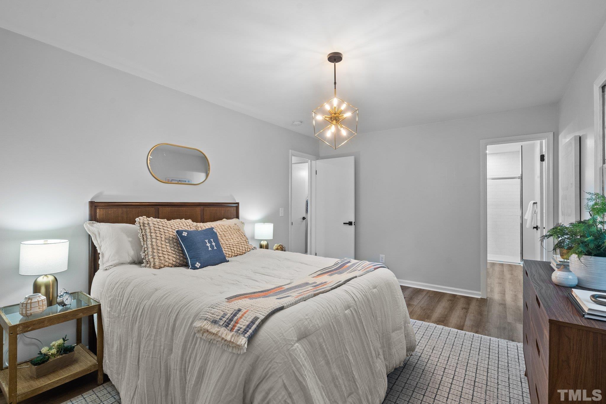 1013 Mockingbird Drive Raleigh, NC 27615 - Photo 26 of 41 a bedroom with bed and wooden floor