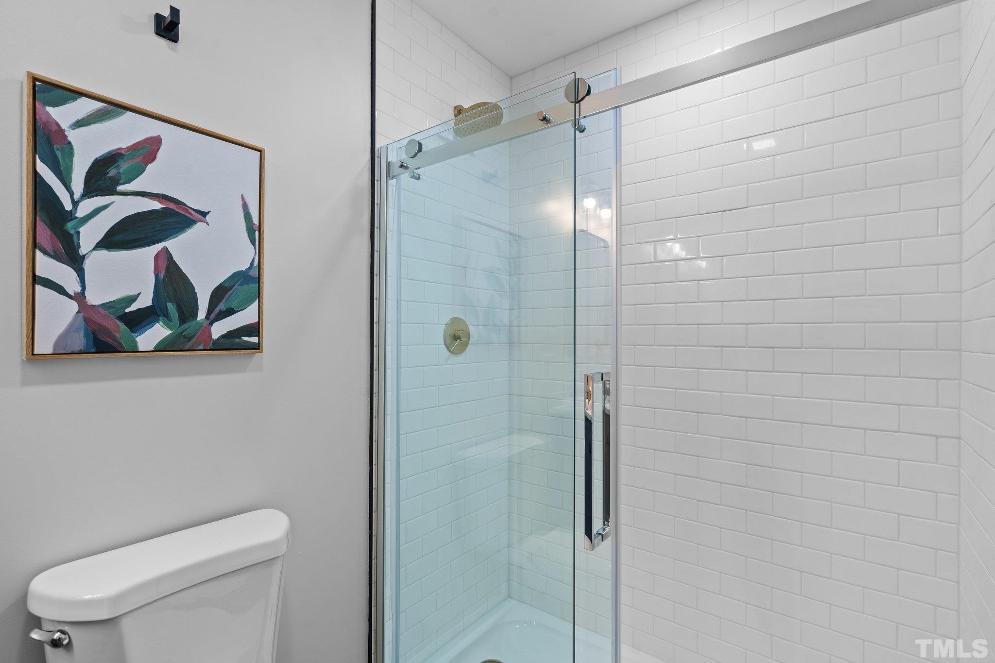 1013 Mockingbird Drive Raleigh, NC 27615 - Photo 28 of 41 a bathroom with a toilet and a shower