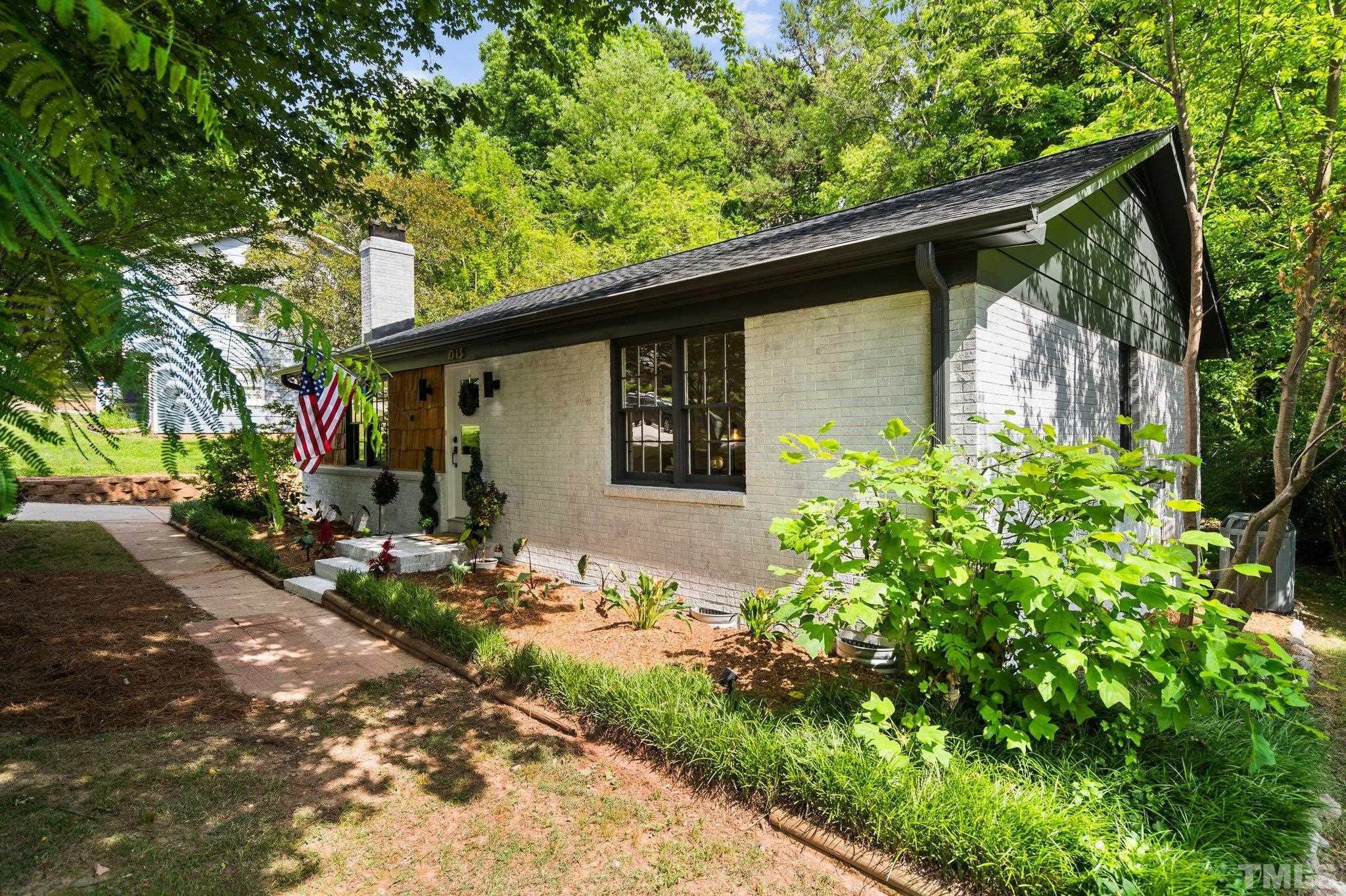 1013 Mockingbird Drive Raleigh, NC 27615 - Photo 3 of 41 a front view of a house with garden