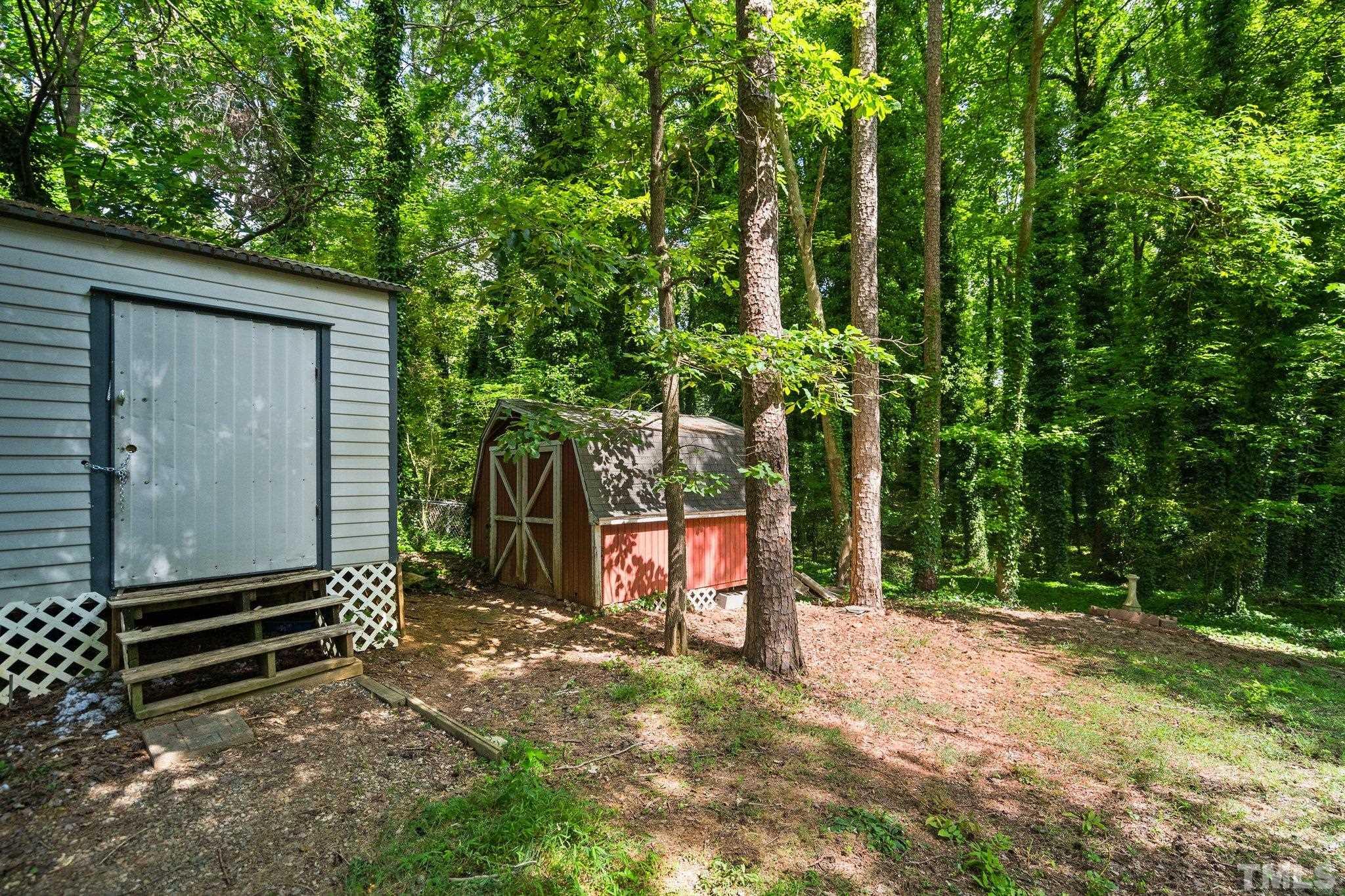 1013 Mockingbird Drive Raleigh, NC 27615 - Photo 35 of 41 a backyard of a house with lots of green space and wooden fence
