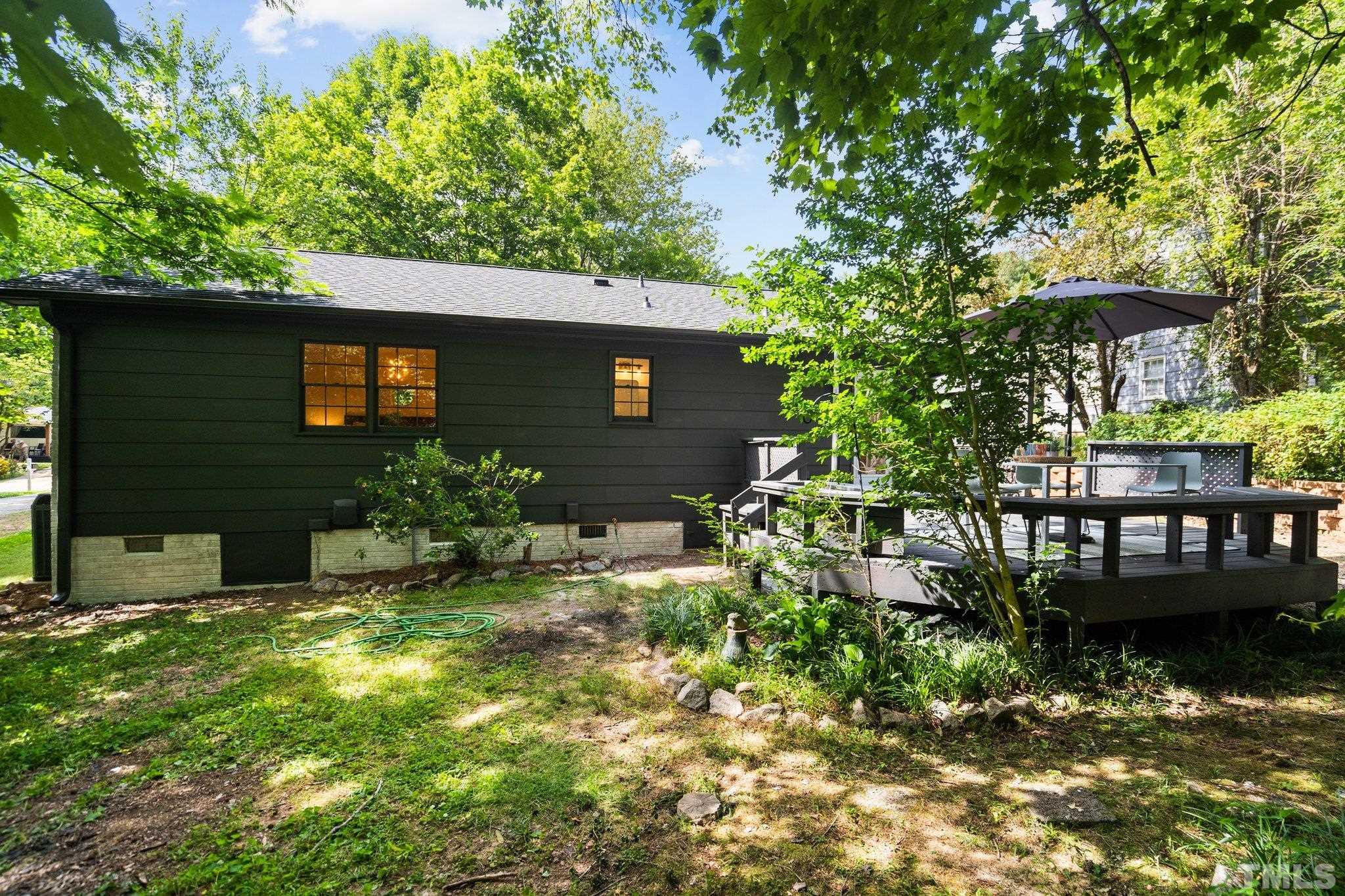 1013 Mockingbird Drive Raleigh, NC 27615 - Photo 37 of 41 a backyard of a house with lots of green space