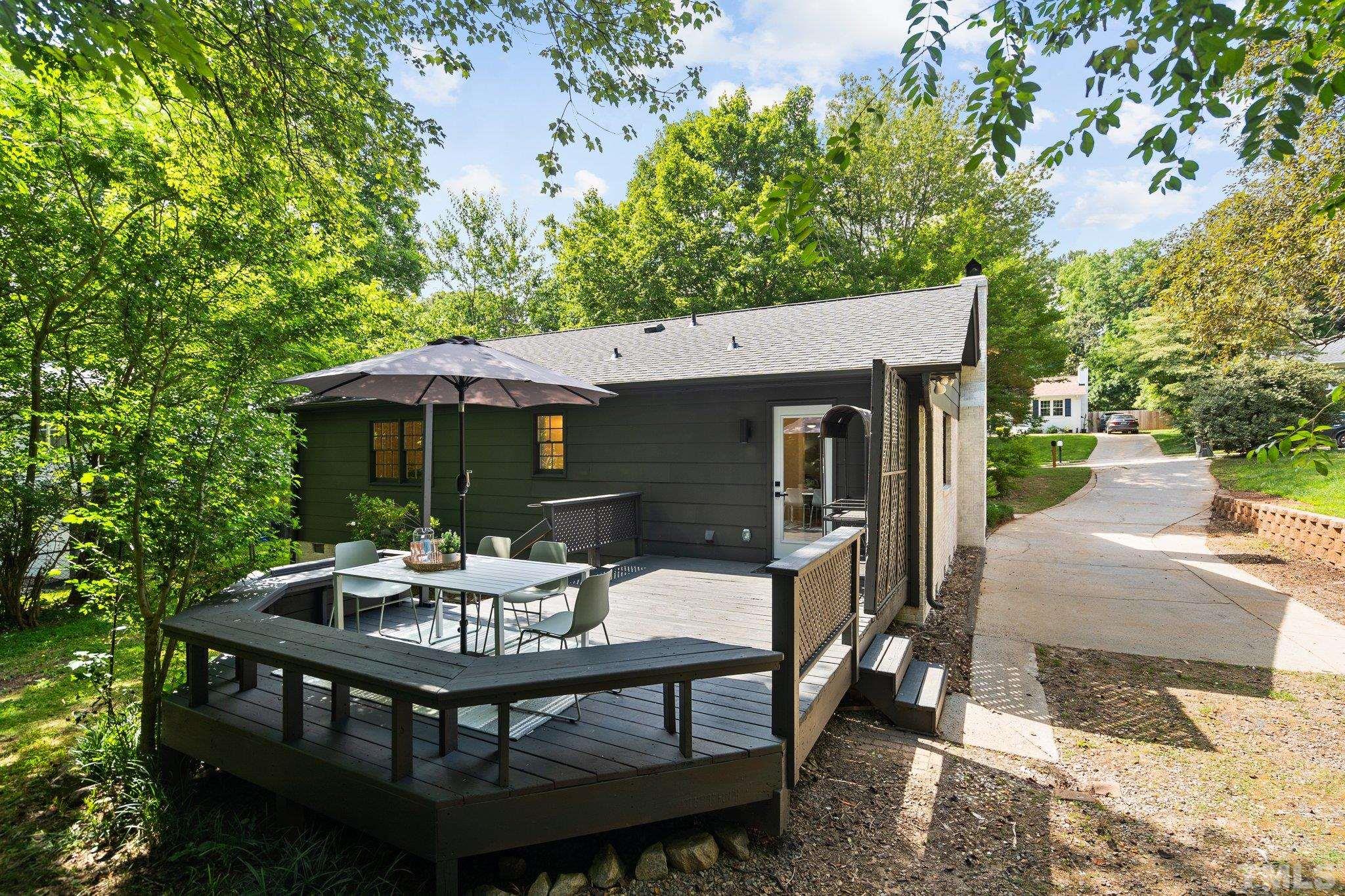 1013 Mockingbird Drive Raleigh, NC 27615 - Photo 38 of 41 a view of a patio with table and chairs with wooden floor and fence