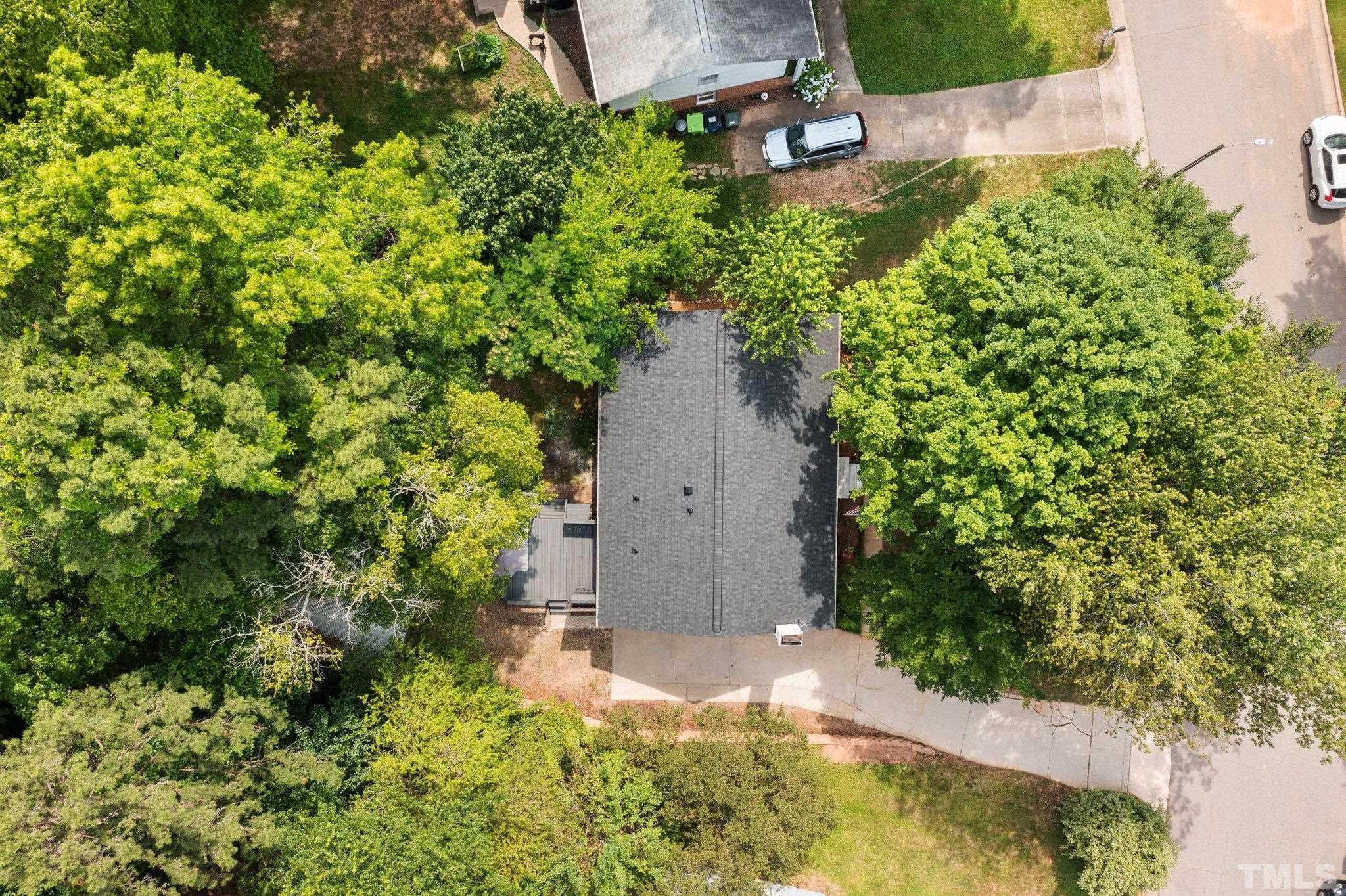 1013 Mockingbird Drive Raleigh, NC 27615 - Photo 39 of 41 an aerial view of a house with a yard and large trees