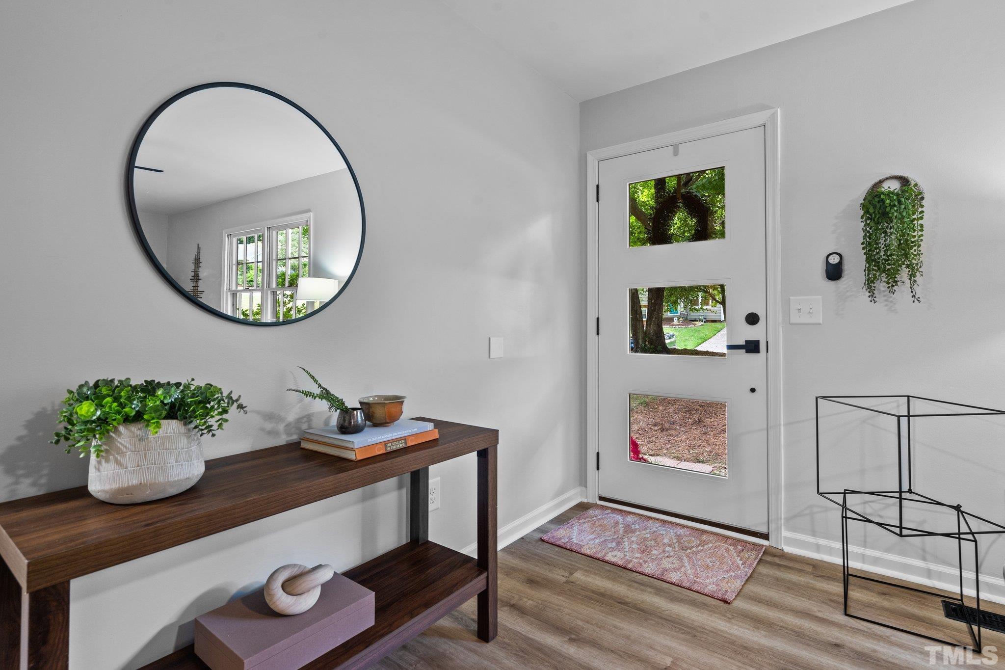 1013 Mockingbird Drive Raleigh, NC 27615 - Photo 6 of 41 a living room with furniture and a potted plant