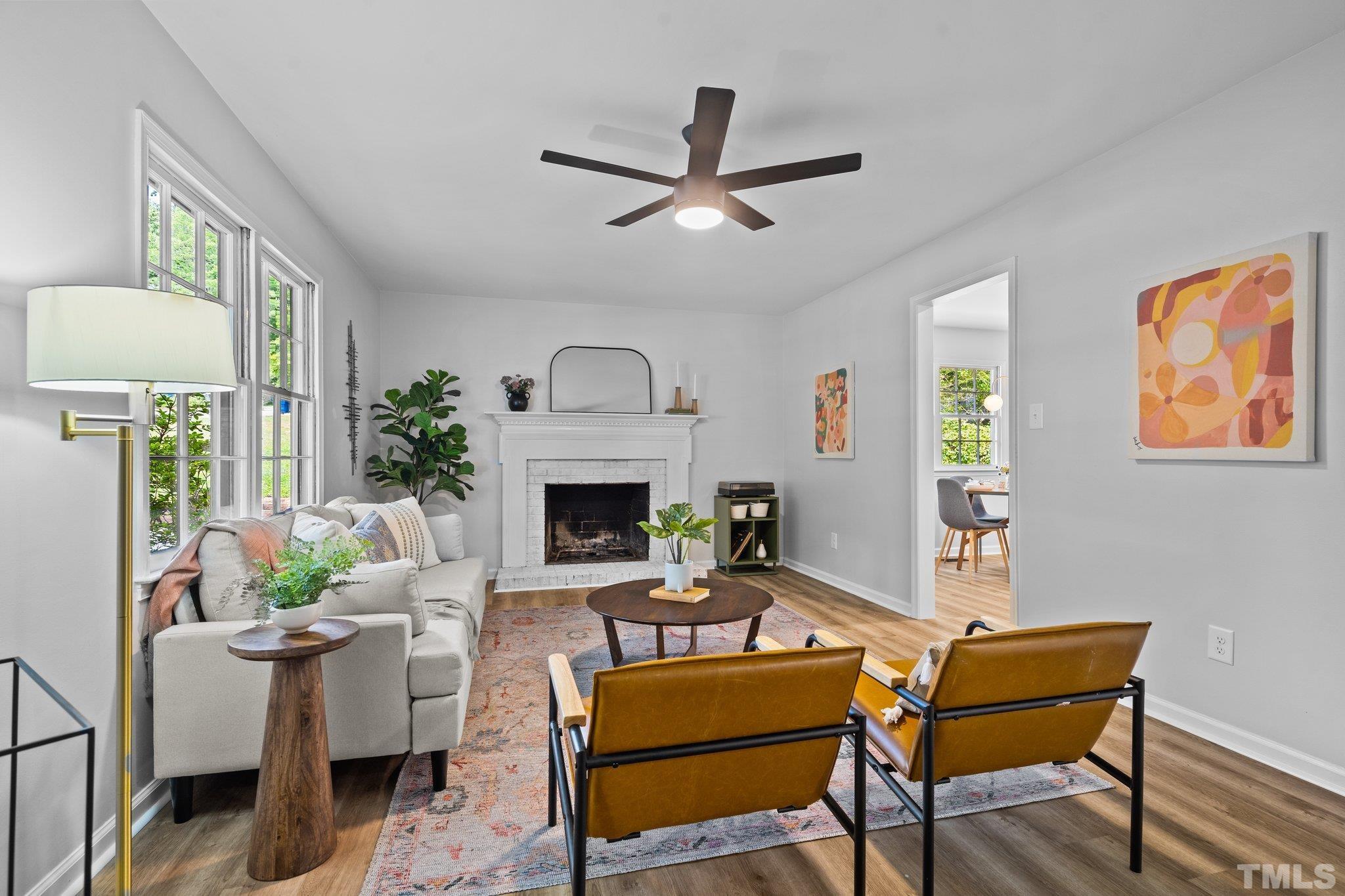 1013 Mockingbird Drive Raleigh, NC 27615 - Photo 7 of 41 a living room with furniture a fireplace and a table