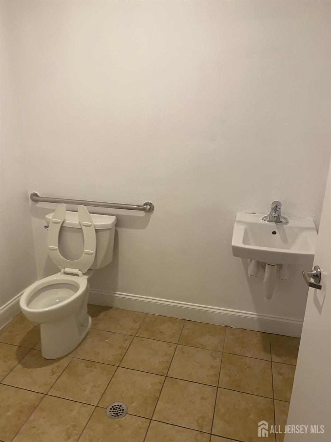 378 George Street, Unit 201 New Brunswick, NJ 08901 - Photo 8 of 10 a bathroom with a toilet and a sink
