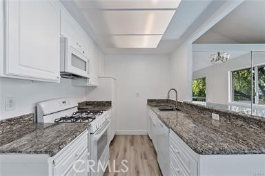 16040 Leffingwell Road, Unit 30 Whittier, CA 90603 - Photo 2 of 15 a kitchen with granite countertop a sink a stove and cabinets