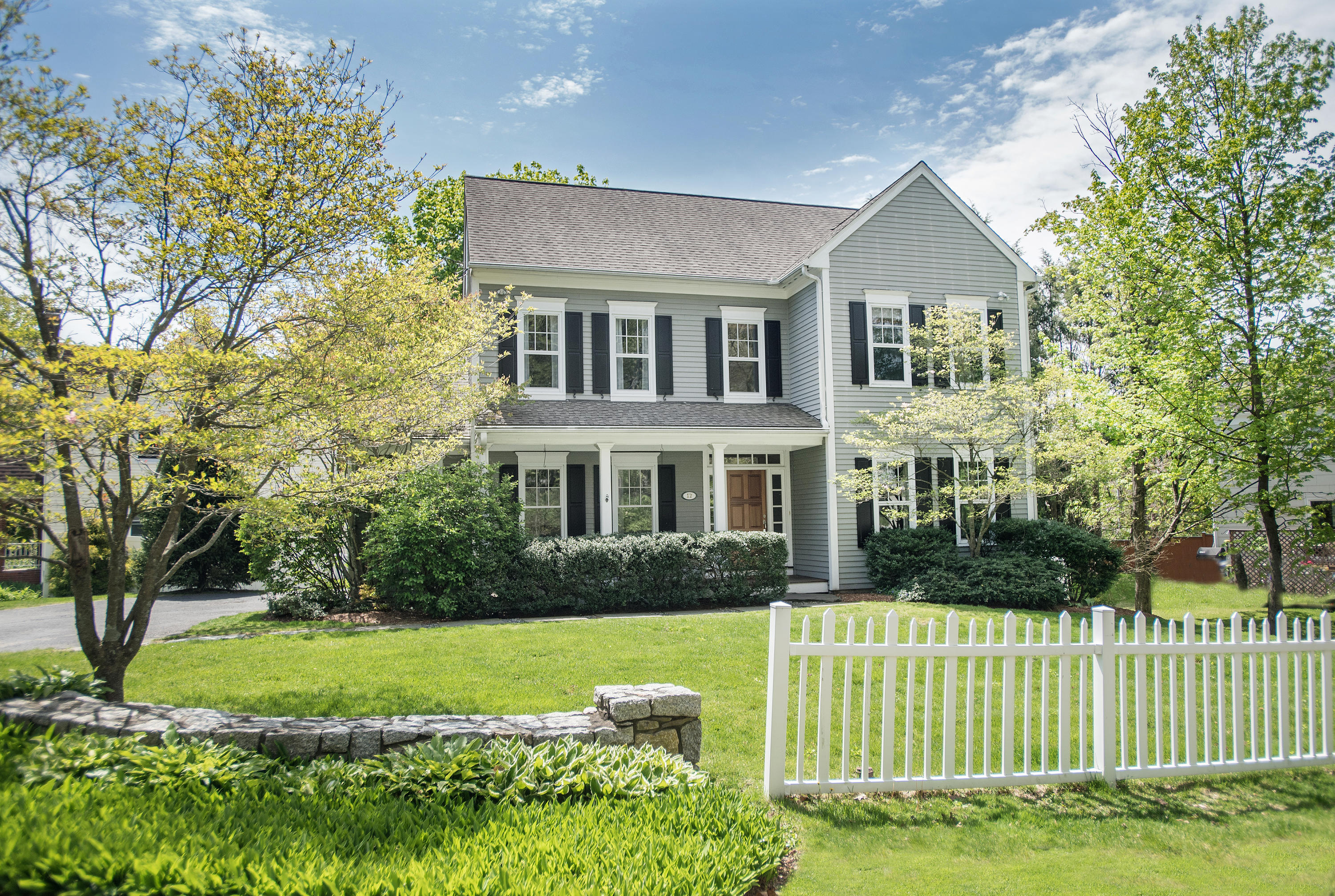 17 Brushy Ridge Road New Canaan, CT 06840 - Photo 1 of 35 a front view of a house with a yard